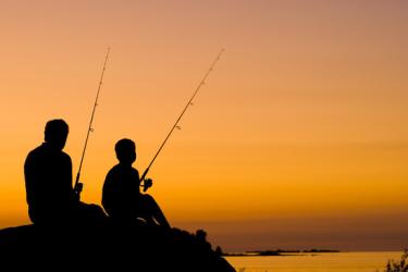 dam-migration-miss/md_rK6VXM8J8m2b.jpg Silhouette/shadows of a man and boy sitting and holding up fishing poles with orange red sunset background